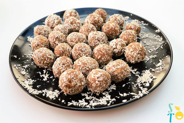 Coconut coated date, almond and chia treat balls